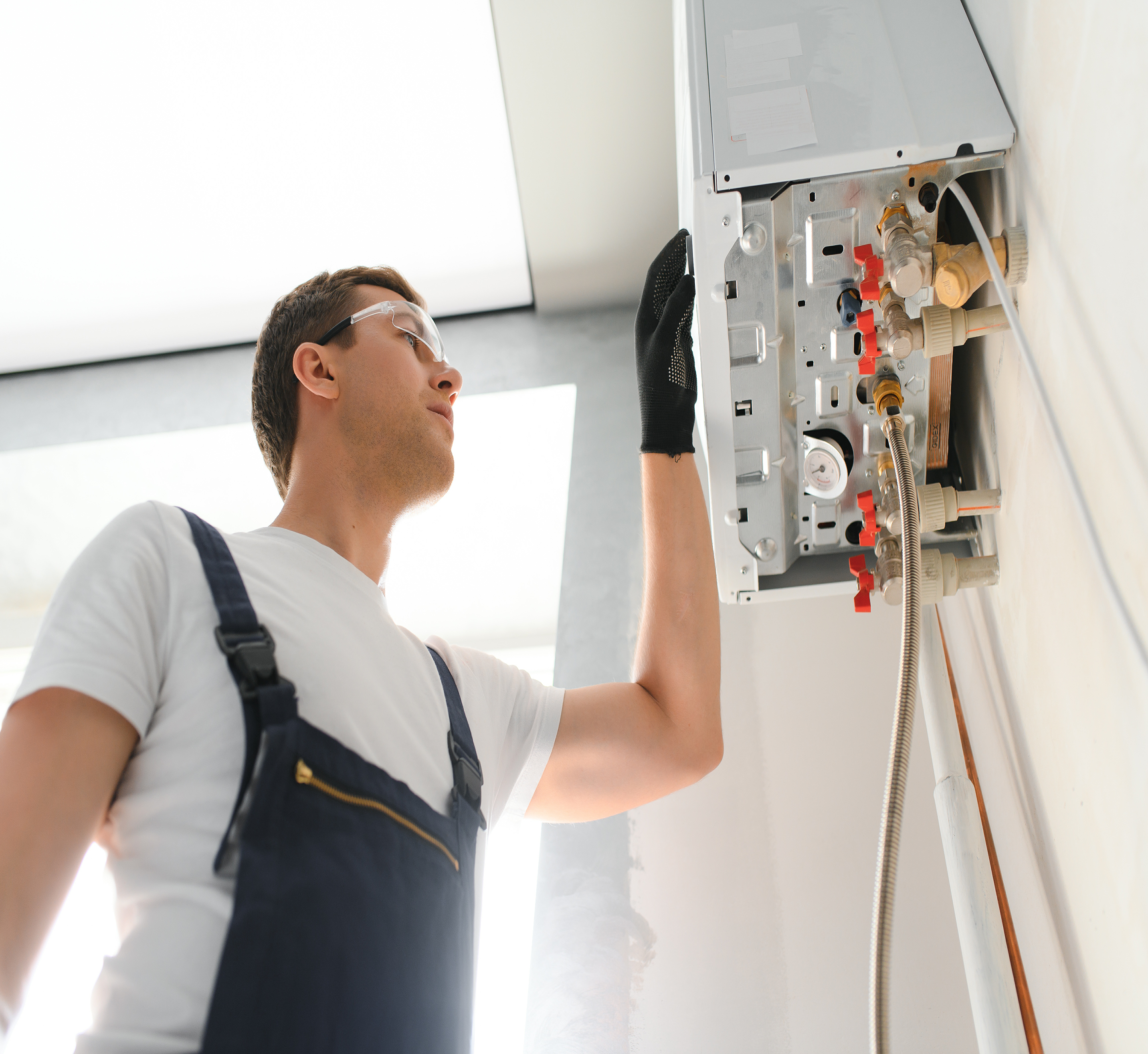 professional-plumber-checking-a-boiler-and-pipes-2025-03-13-15-33-47-utc